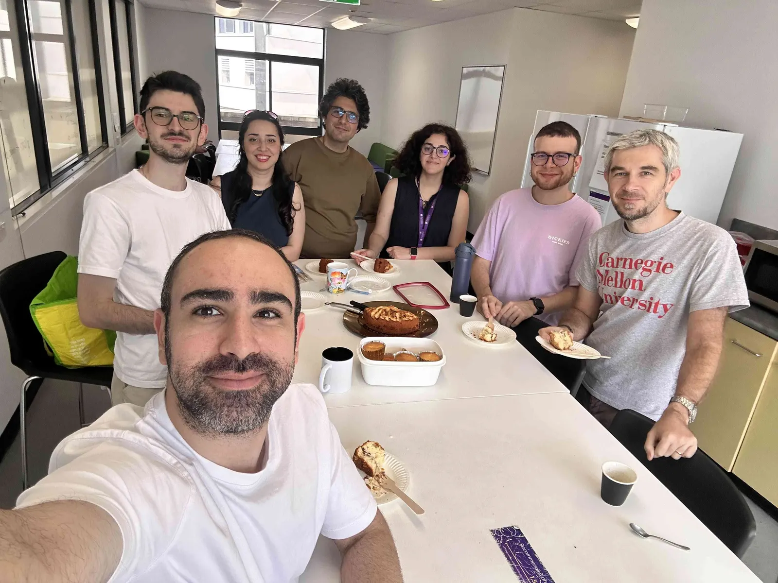 Lab members around a table during a shared lunch in the office