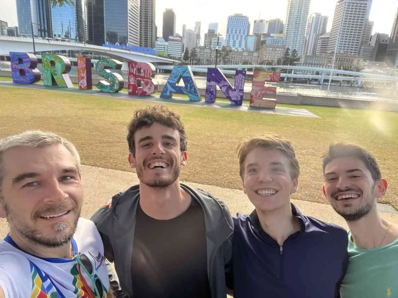 Lab members taking a selfie in front of the Brisbane sign at South Bank
