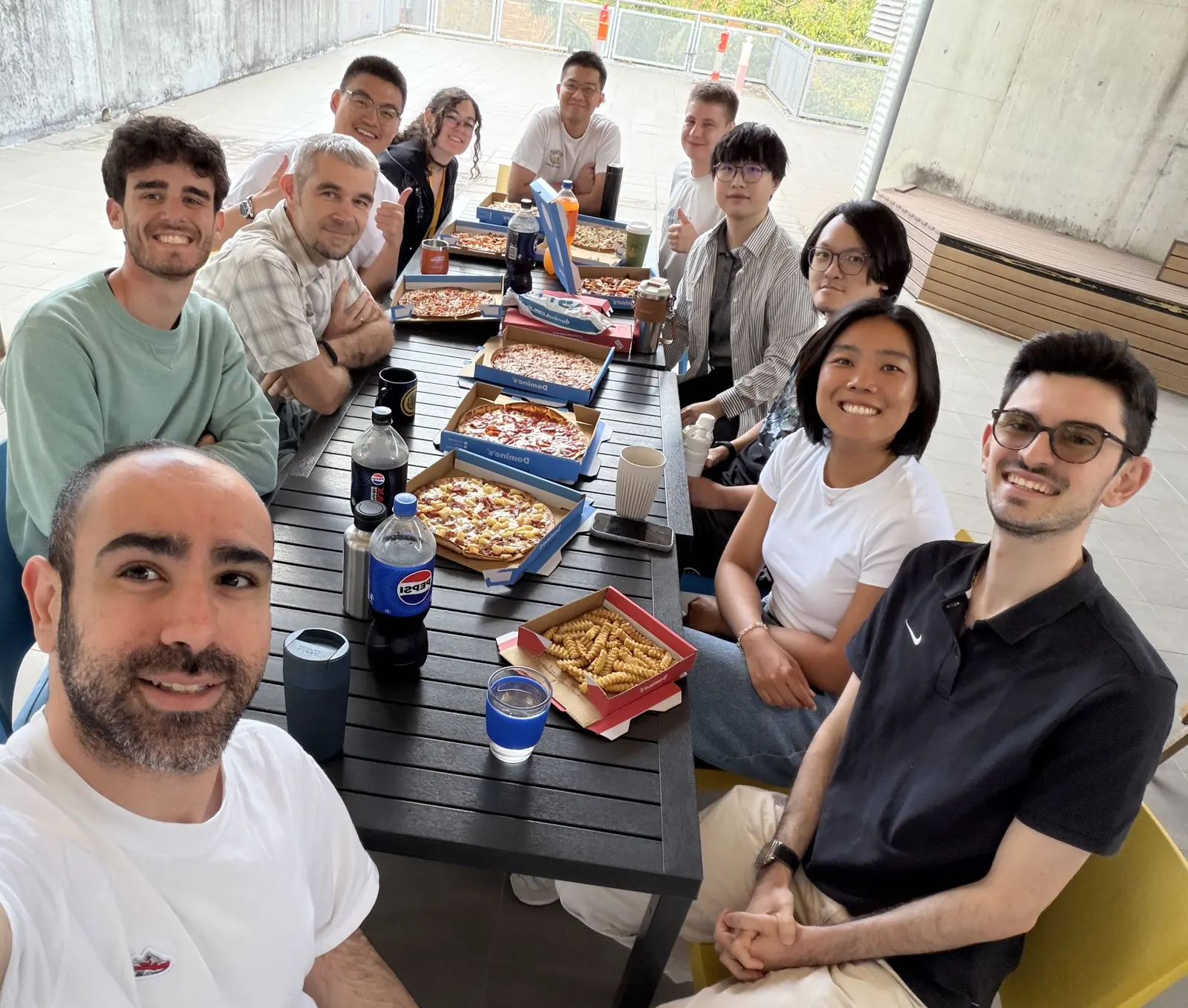 DLab members sharing pizza at a lab lunch