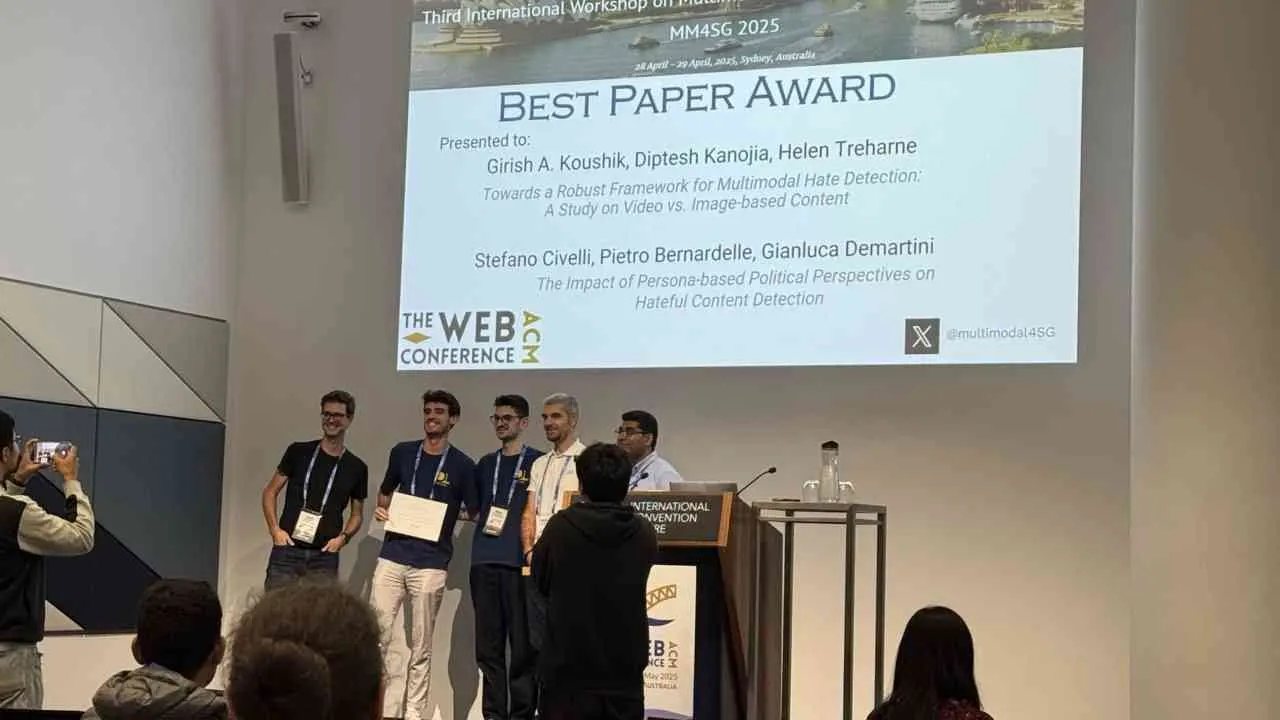 DLab researchers receiving a best paper award on stage at The Web Conference