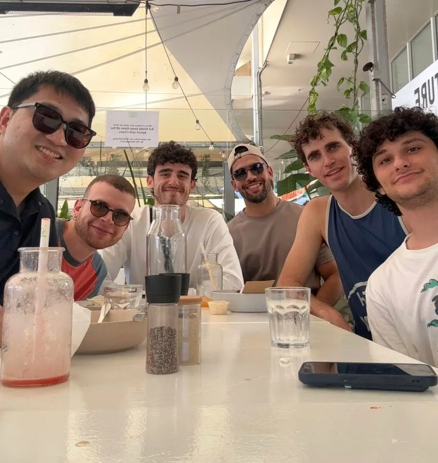 Lab members smiling over lunch at a cafe