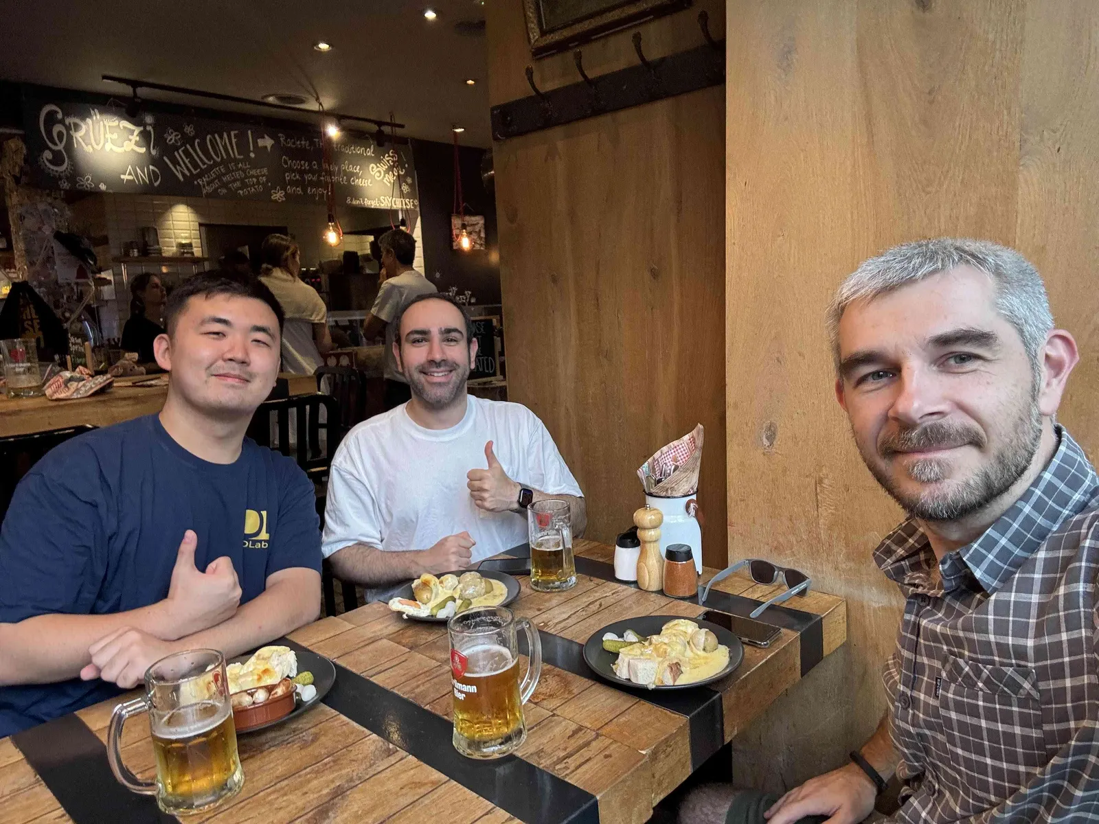 Lab members taking a selfie at a restaurant table