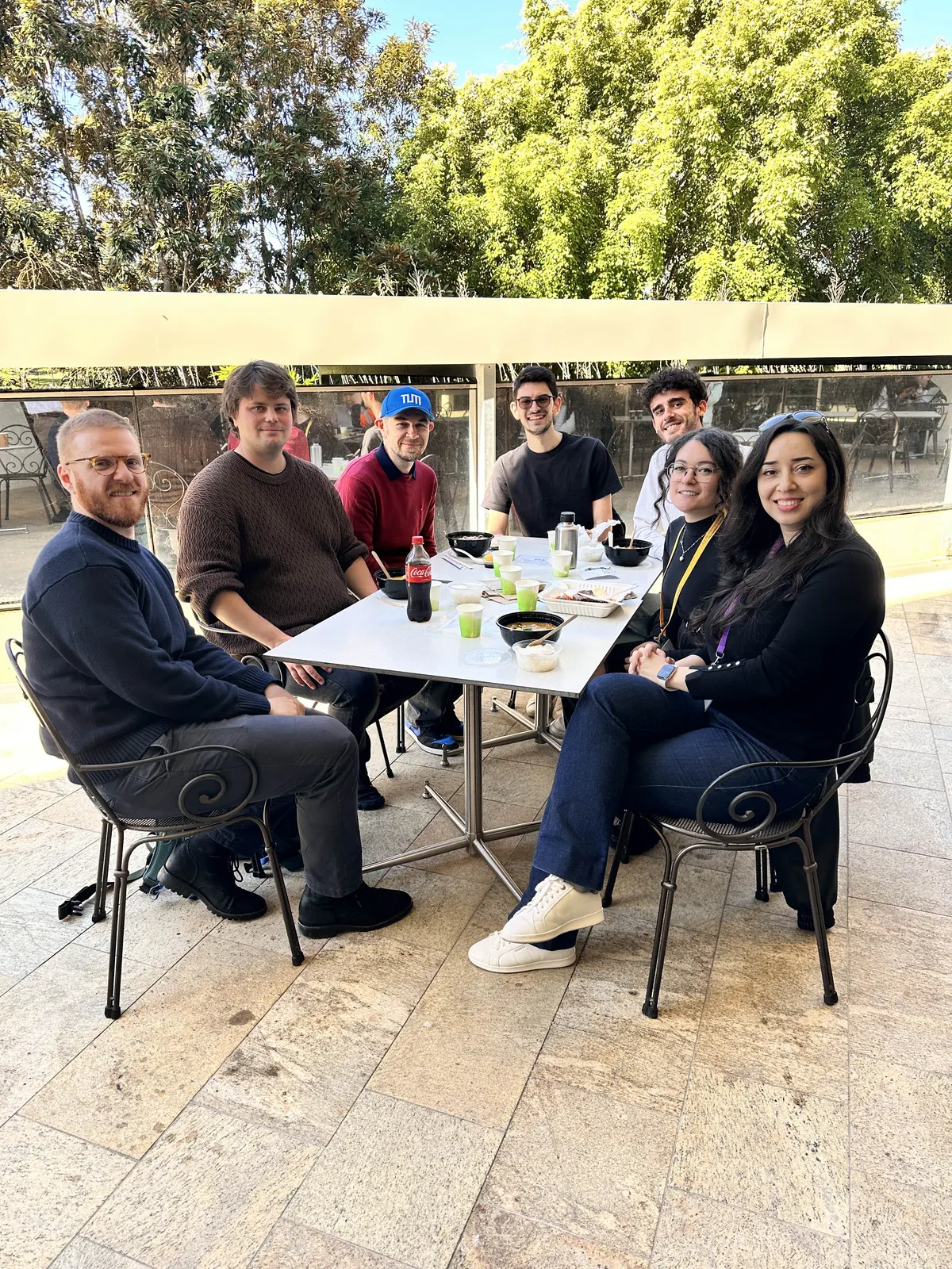 DLab members sharing lunch at an outdoor table